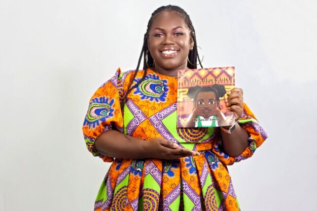 Jamaican author Susan Smith proudly holds her new book "Little Black Girl."