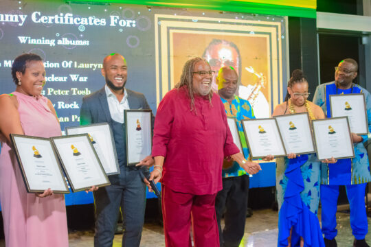 Saxophonist Dean Fraser collecting his 9 Grammy-winning certificates